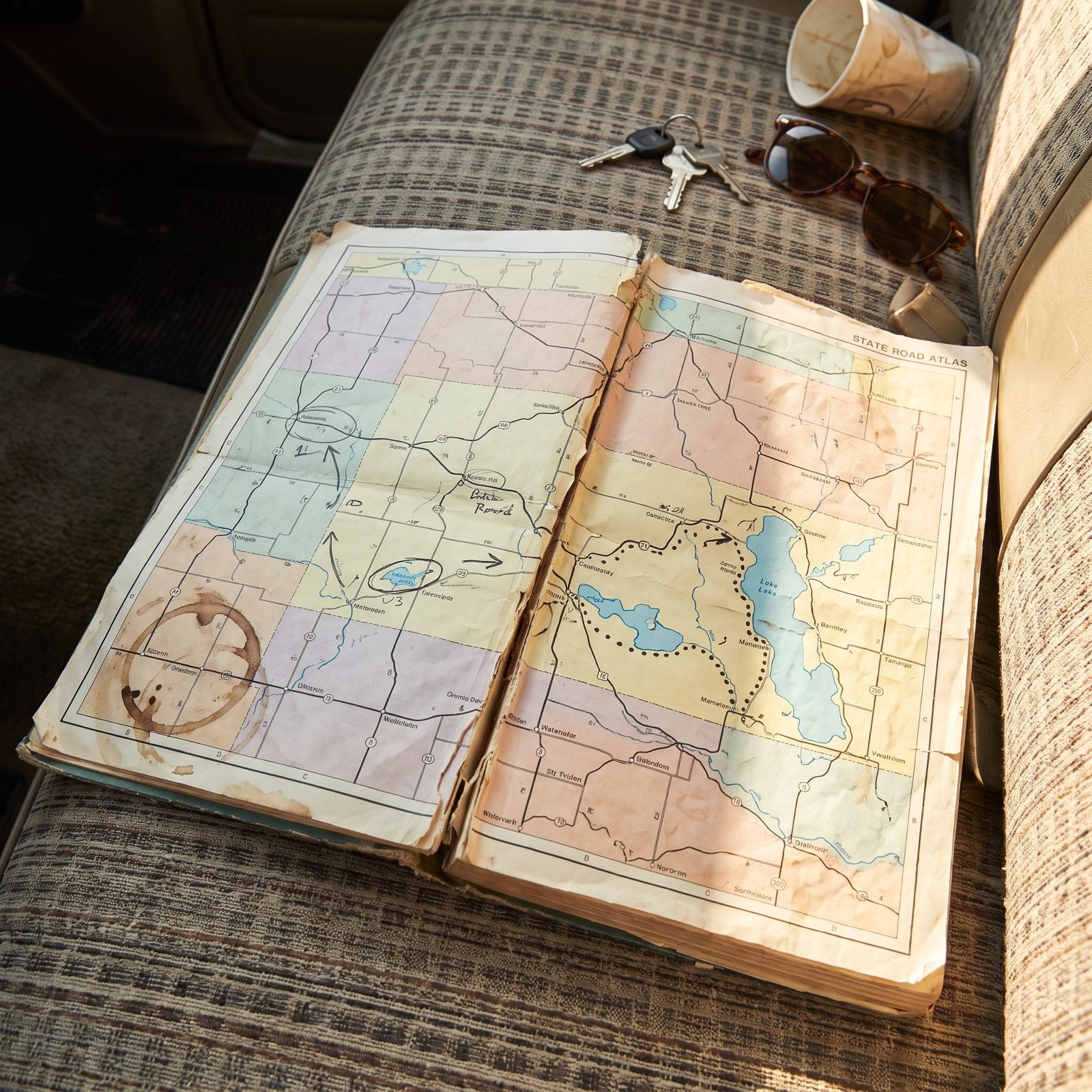 A Dog-Eared State Road Atlas Marked With Back Routes