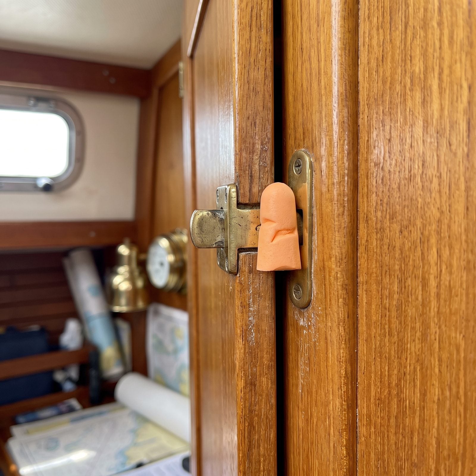 Put a Foam Earplug Behind a Loose Latch as a Temporary Rattle Stop