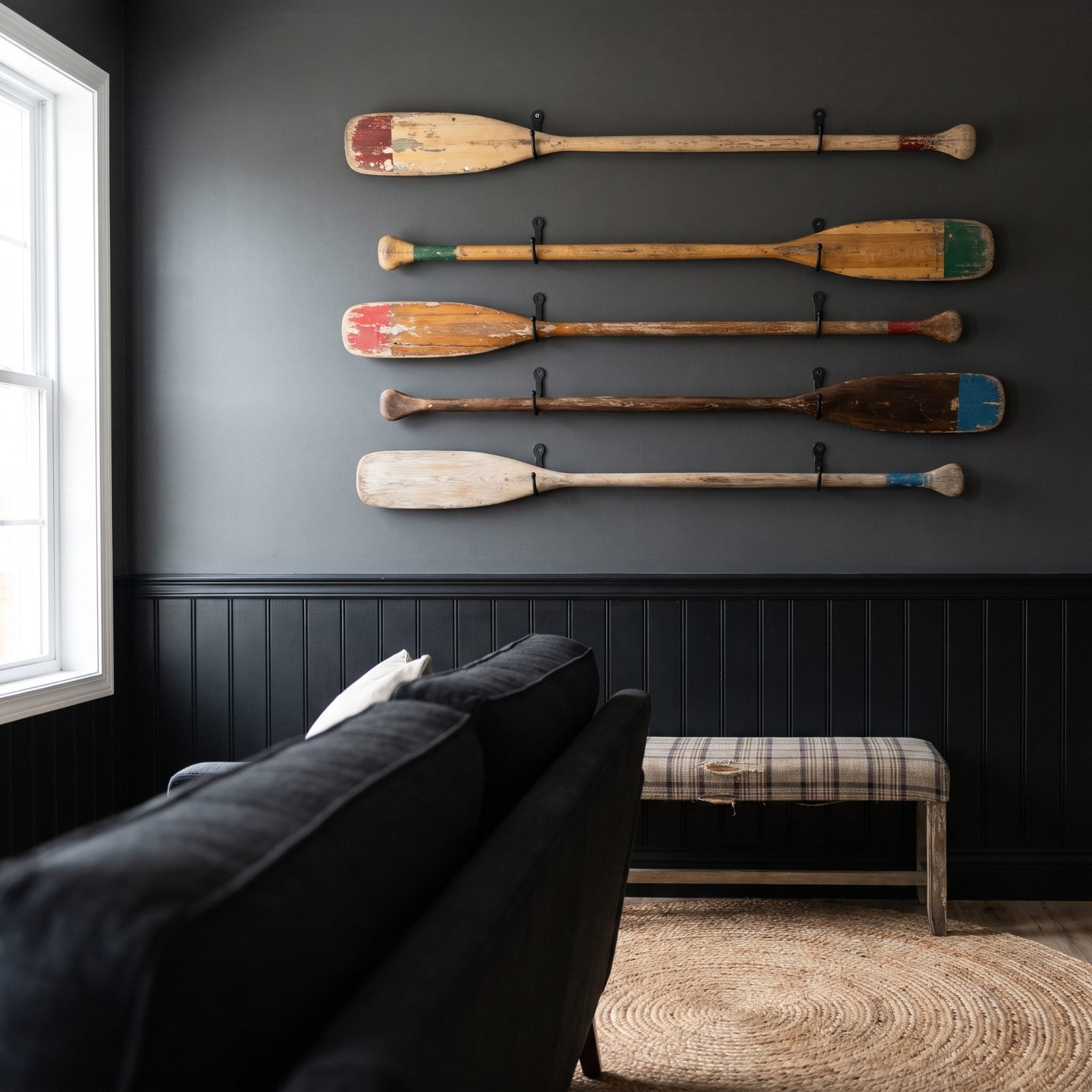 A Row of Worn Wooden Paddles on the Wall